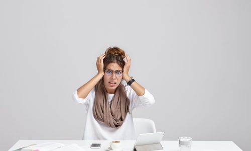 attractive-casually-dressed-young-female-secretary-stylish-eyewear-holding-hands-head (1)